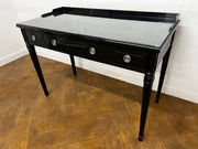 A 3 Drawer Dressing Table with Glass Top Finished in Black Lacquer.
