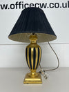 A Wooden Painted Gold and Black Fluted Table Lamp and Shade