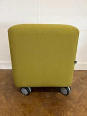 Used Task Padded Green Fabric Cube Stool on Wheels.