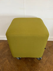 Used Task Padded Green Fabric Cube Stool on Wheels.