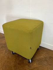 Used Task Padded Green Fabric Cube Stool on Wheels.