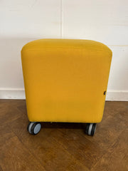 Used Task Padded Yellow Cloth Cube Stool on Wheels.