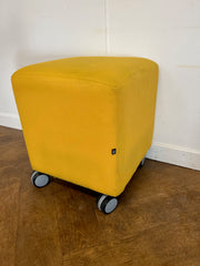 Used Task Padded Yellow Cloth Cube Stool on Wheels.