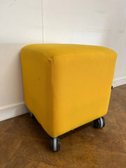 Used Task Padded Yellow Cloth Cube Stool on Wheels.