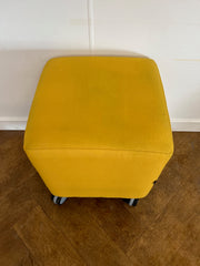 Used Task Padded Yellow Cloth Cube Stool on Wheels.