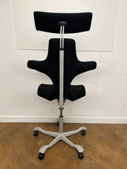 Used HAG Capisco 8107 Saddle Chair in Black Cloth with Headrest and Silver Base.