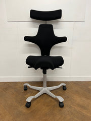 Used HAG Capisco 8107 Saddle Chair in Black Cloth with Headrest and Silver Base.