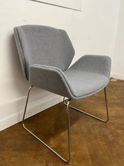 Used Boss Design Kruze Lounge Chair with Steel Sled Base Re-upholstered in Grey cloth.